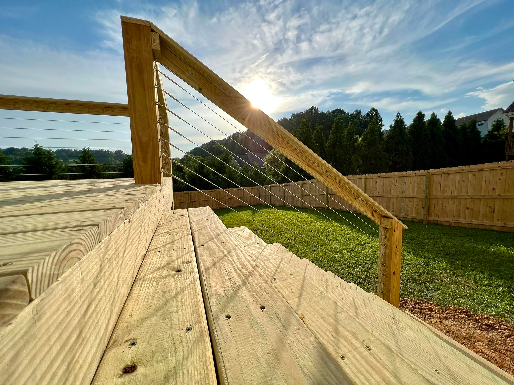 Pristine deck stairs with cable handrail.