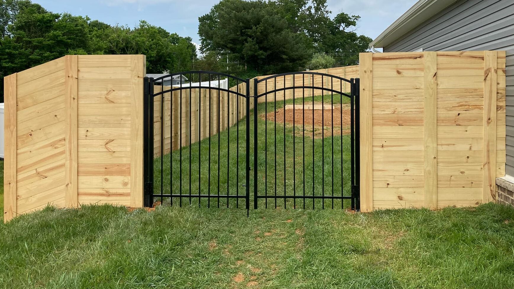 Horizontal wood fence with stylish gate.