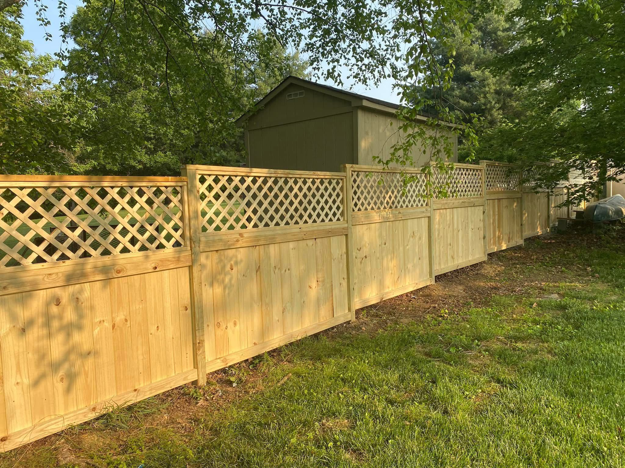 Wood fence with decorative lattice.